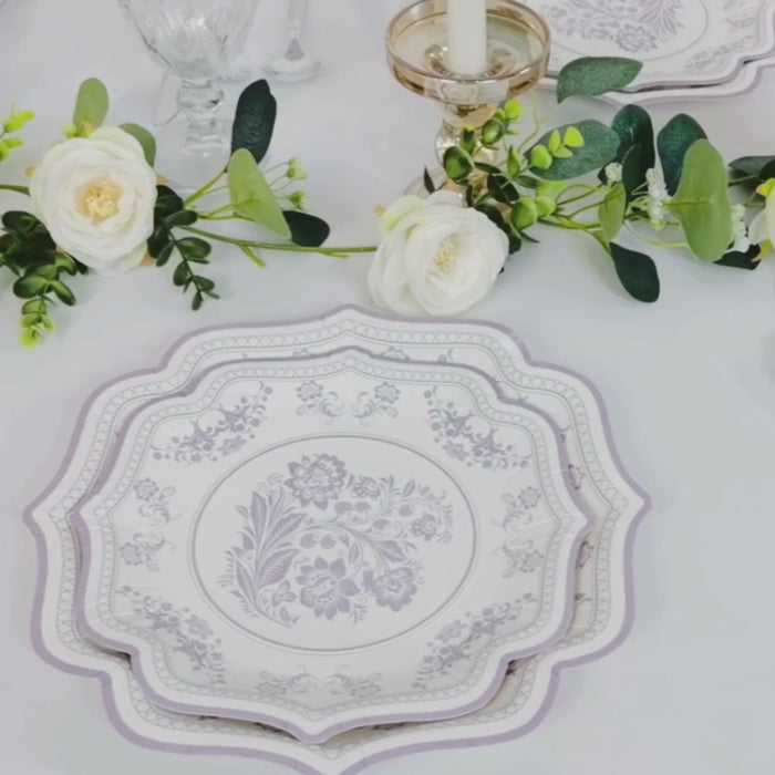 White lavender floral dinner plate with scallop rim on a table setting.