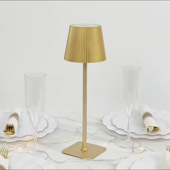 Gold LED table lamp with adjustable height and ribbed shade.