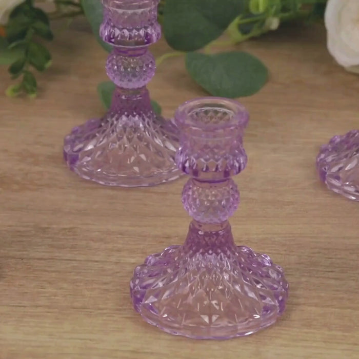 Lavender lilac glass taper candlestick holders with diamond pattern design.