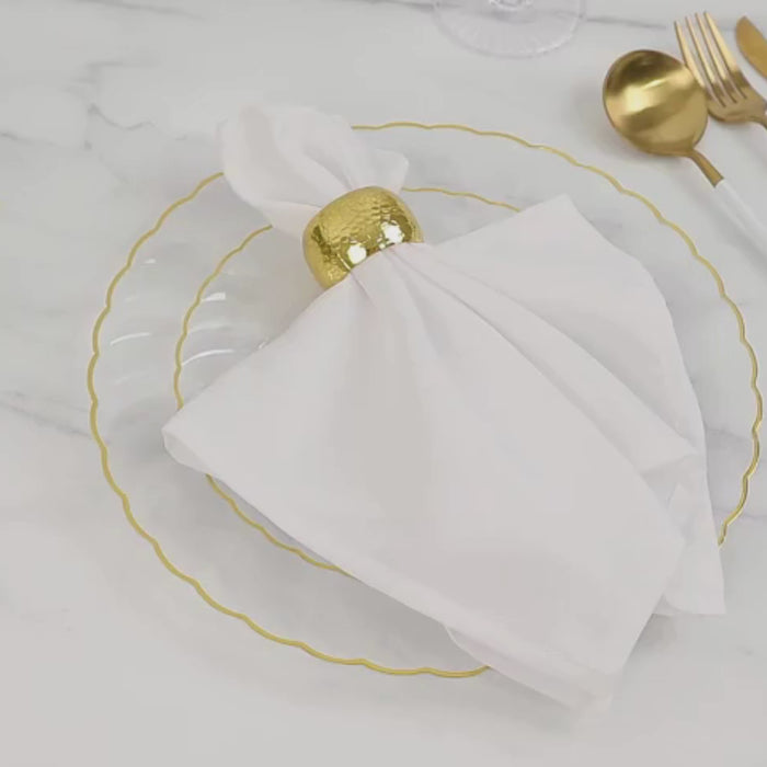 Clear plastic round salad plates with gold flair rim, ideal for elegant celebrations.