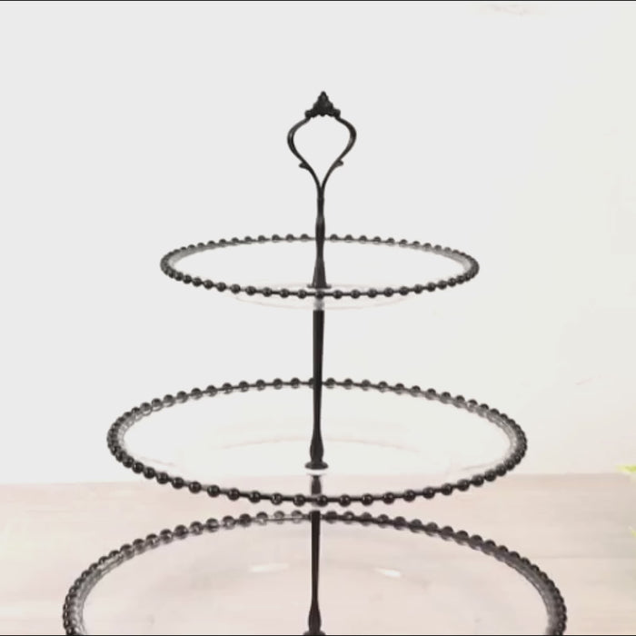 Clear 3-tier round cupcake tower stand with black beaded rim and top handle.