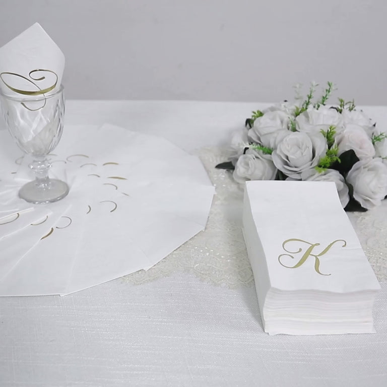 White paper dinner napkins with gold foil monogram "A".