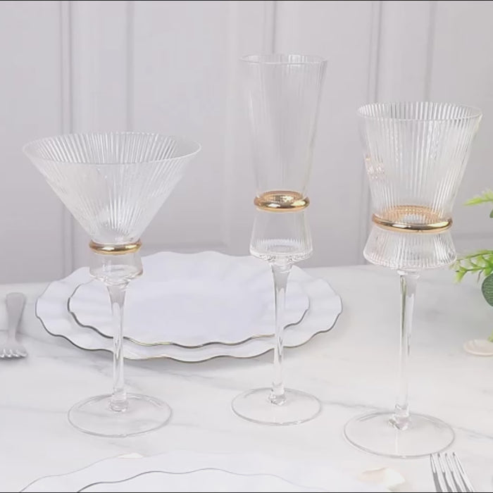Clear ribbed champagne flutes with gold ring accents, elegant for celebrations.