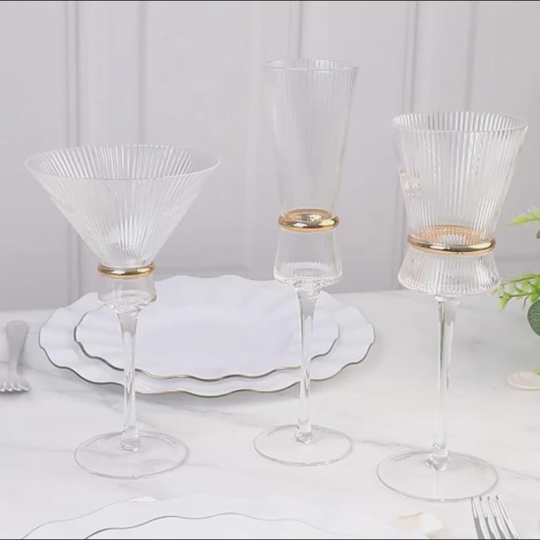 Clear ribbed champagne flutes with gold ring accents, elegant for celebrations.