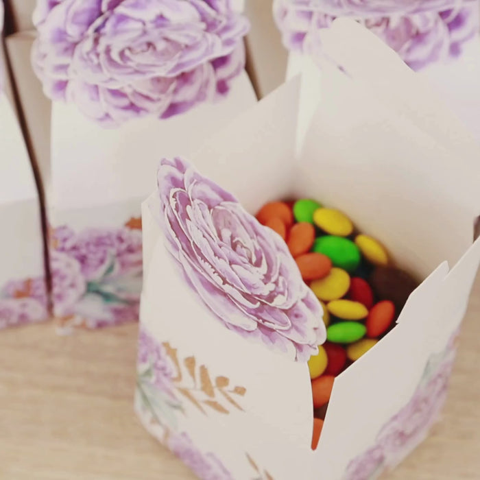 Lavender peony floral party favor boxes filled with colorful candies.
