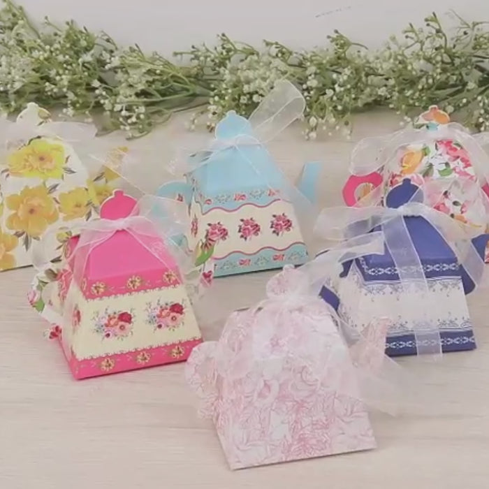 Mixed vintage floral party favor boxes in pastel colors.