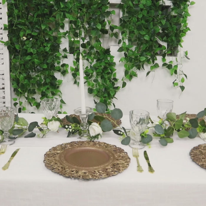 Round brown charger plates with brushed gold vintage floral rim on a decorated table.