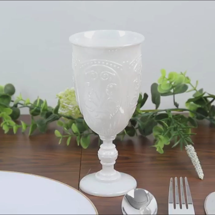 Pearl white vintage goblet on a table with greenery.