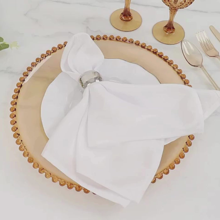 Amber gold charger plate with beaded rim, elegantly set for a dinner party.