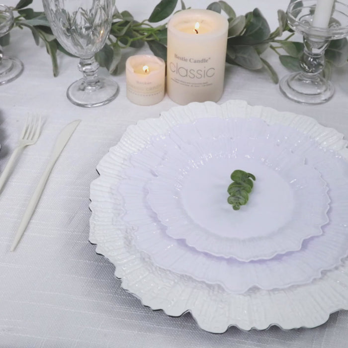 White reef design plastic plates set on a table for a dinner party.