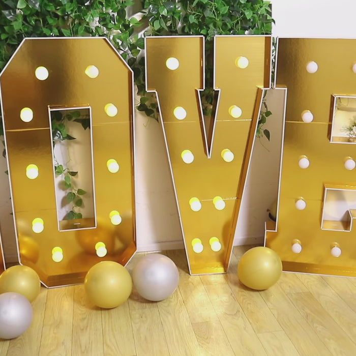 Gold LED marquee letter "N" with warm white lights.