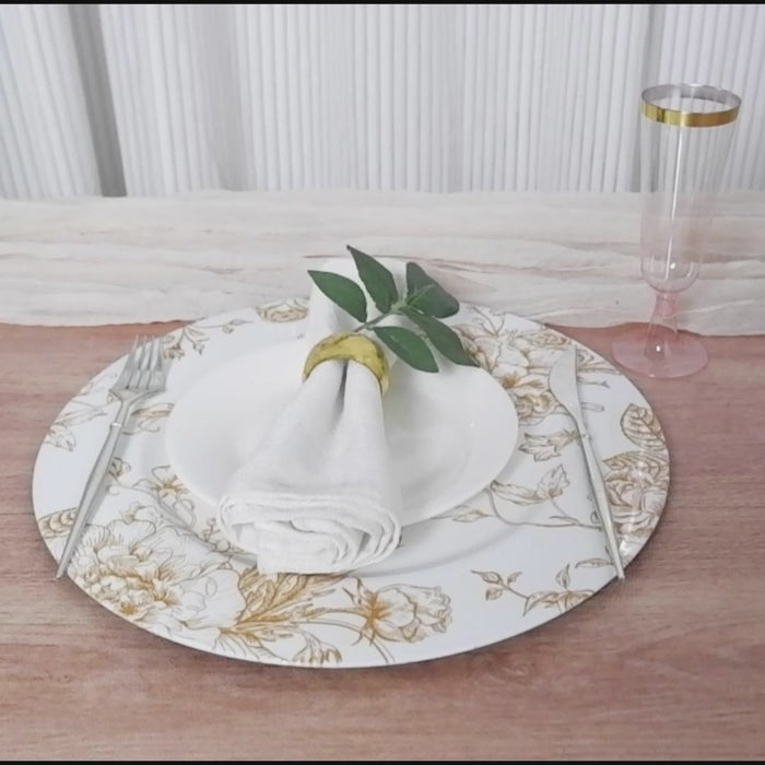 White charger plate with gold floral pattern, perfect for elegant dinner settings.