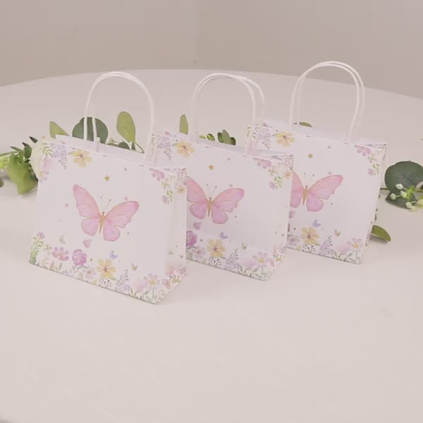 Pink glitter butterfly gift bags with floral print, perfect for party favors.