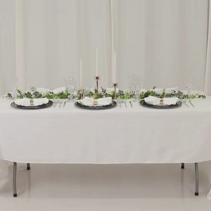 Hunter emerald green beaded rim charger plates on a dining table.