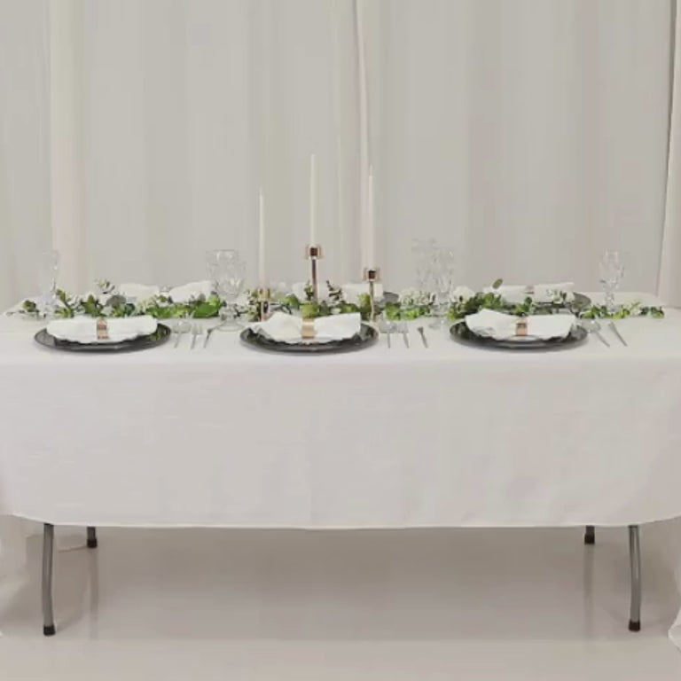 Hunter emerald green beaded rim charger plates on a dining table.