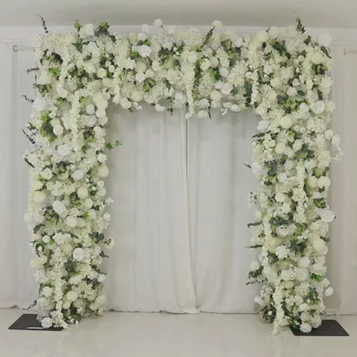 White flower backdrop with artificial roses, hydrangeas, and chrysanthemums.