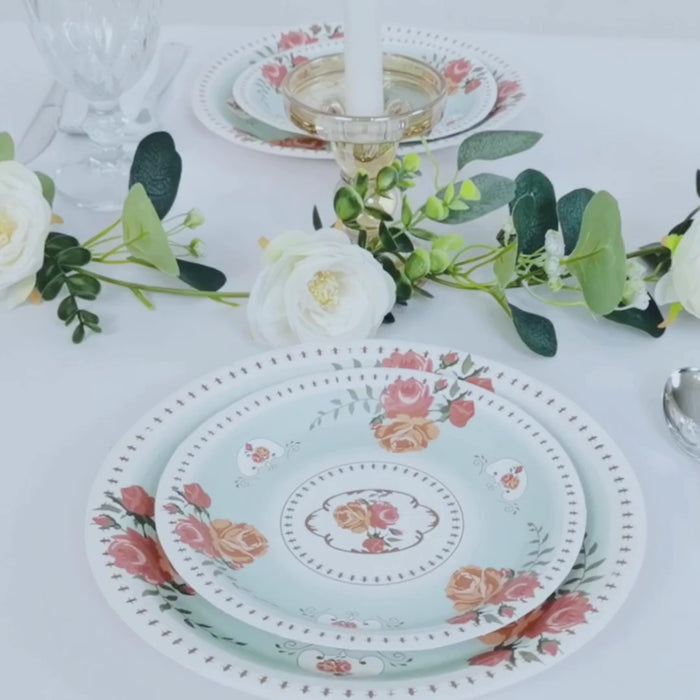 Light turquoise dessert plates with vintage rose flower print on a table setting.