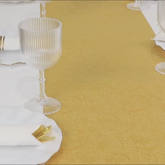 Gold glitter table runner with vintage floral vine pattern on a table setting.