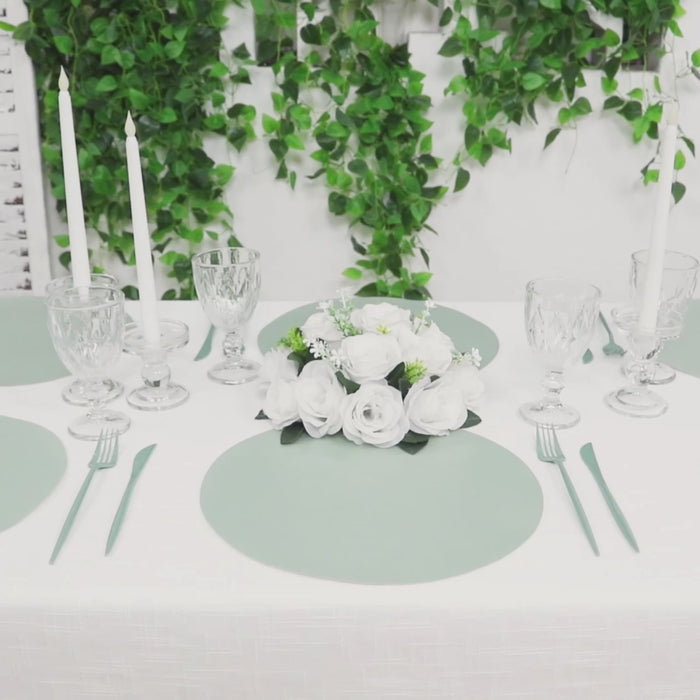 Sage green disposable paper placemats on a dining table setting.