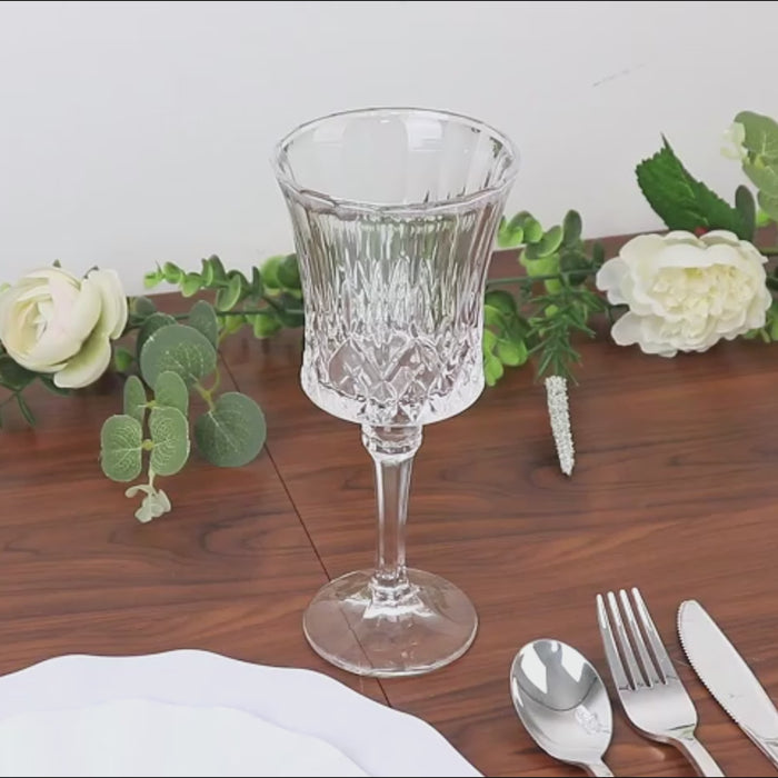 Clear crystal cut glass goblet on a table with floral decor.