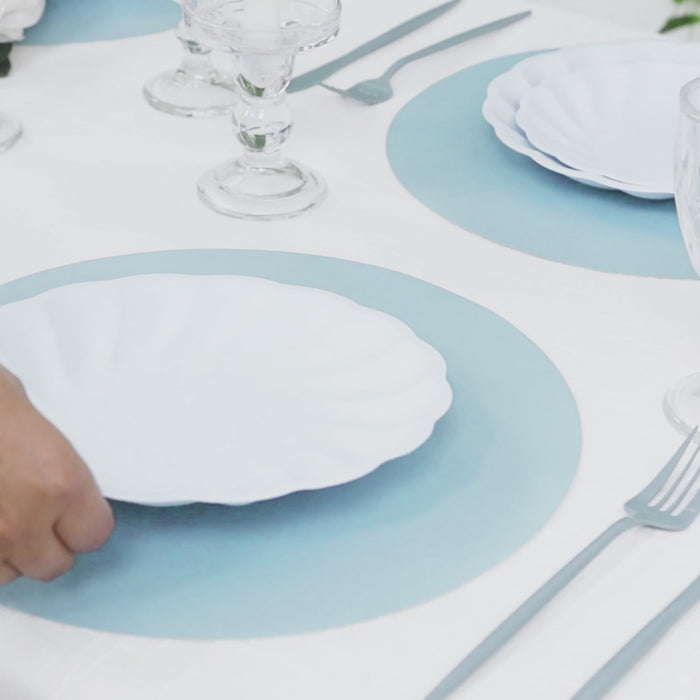 Dusty blue disposable paper placemats on a dining table setting.