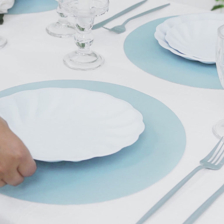Dusty blue disposable paper placemats on a dining table setting.