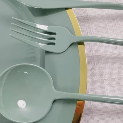 Dusty sage green heavy-duty plastic utensil set on a plate.