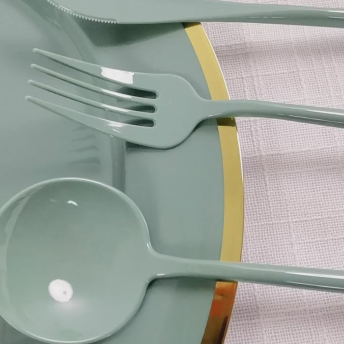 Dusty sage green heavy-duty plastic utensil set on a plate.