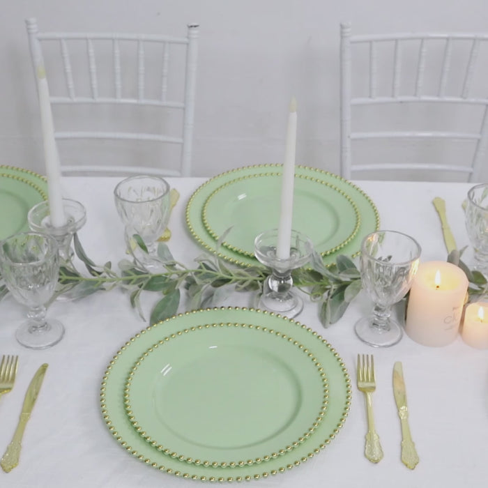 Sage green charger plates with gold beaded rim for elegant dinner settings.