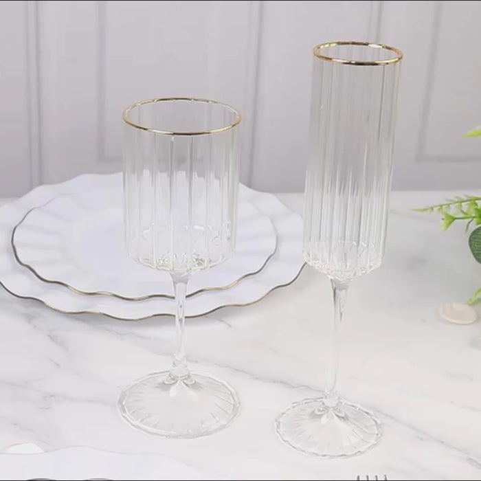Clear ribbed champagne flutes with gold rim, elegant for weddings and celebrations.