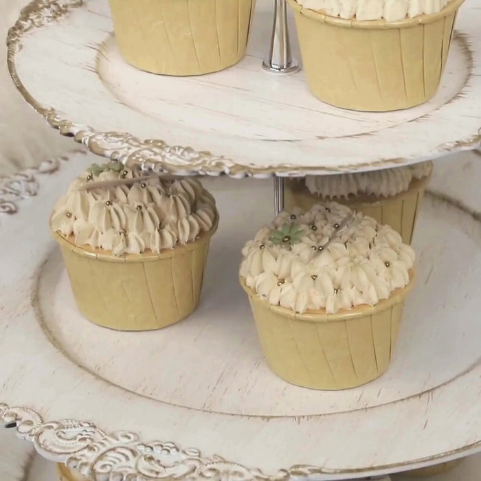 Whitewashed 3-tier cupcake stand with decorated cupcakes.