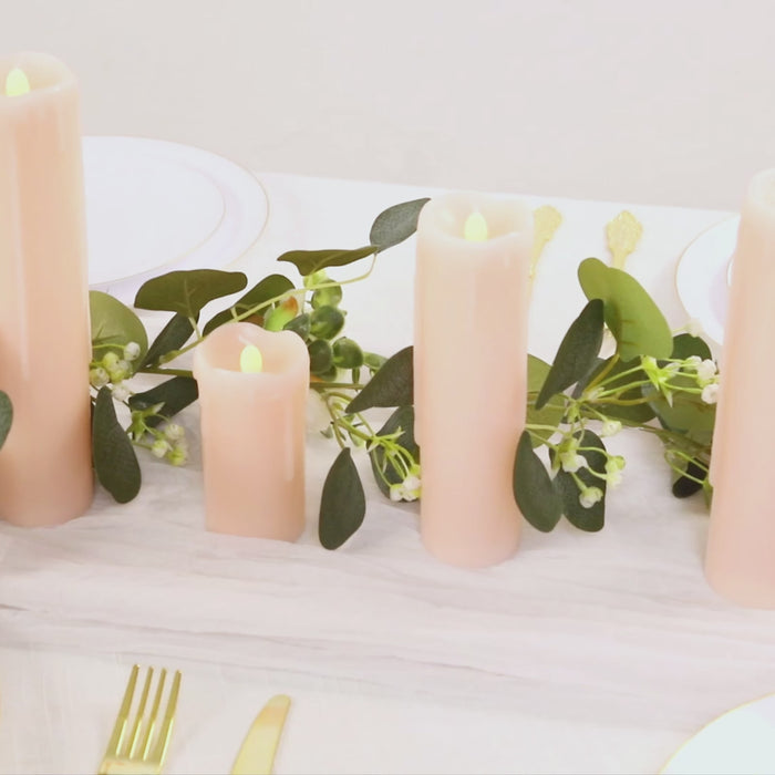Blush LED drip wax pillar candles for flameless luminaria lighting.