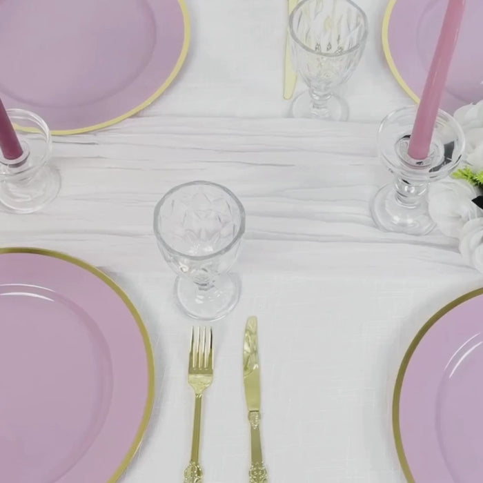 Lavender lilac charger plates with gold rim on a dinner table setting.