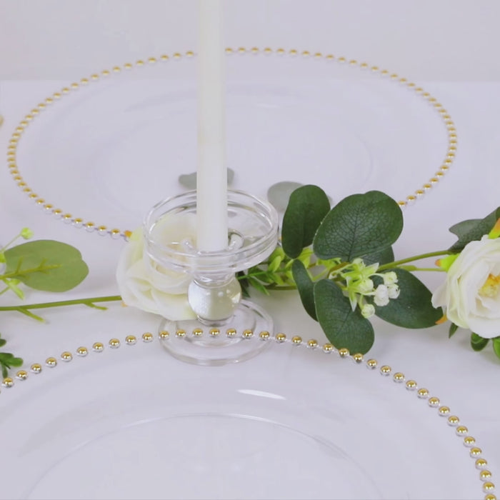 Clear charger plates with gold beaded rim for elegant table settings.