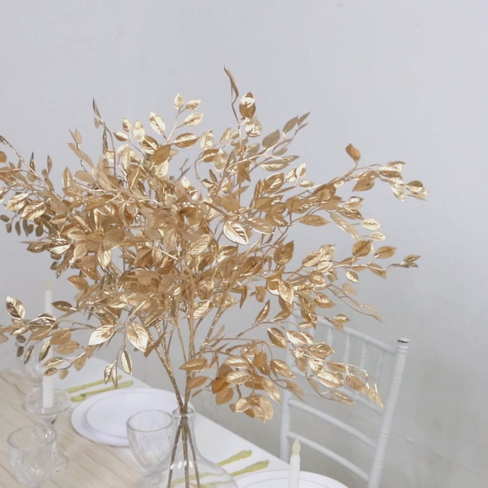 Gold metallic artificial leaf stems for floral arrangements and centerpieces.