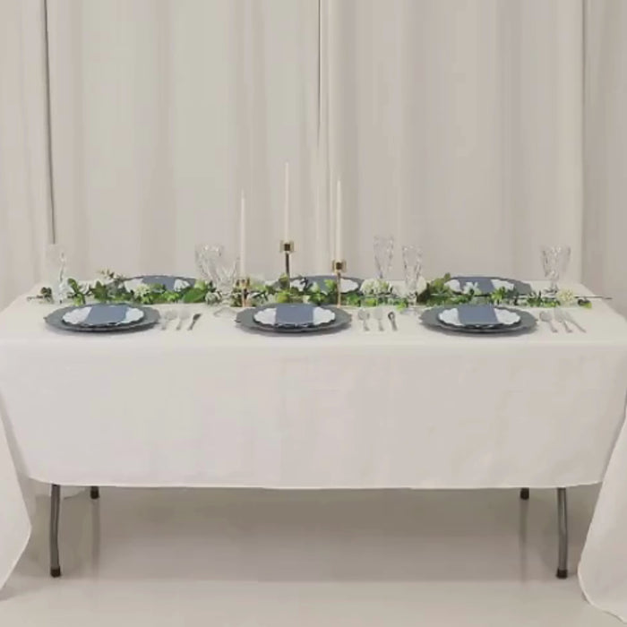 Dusty blue charger plates on a beautifully set dining table.