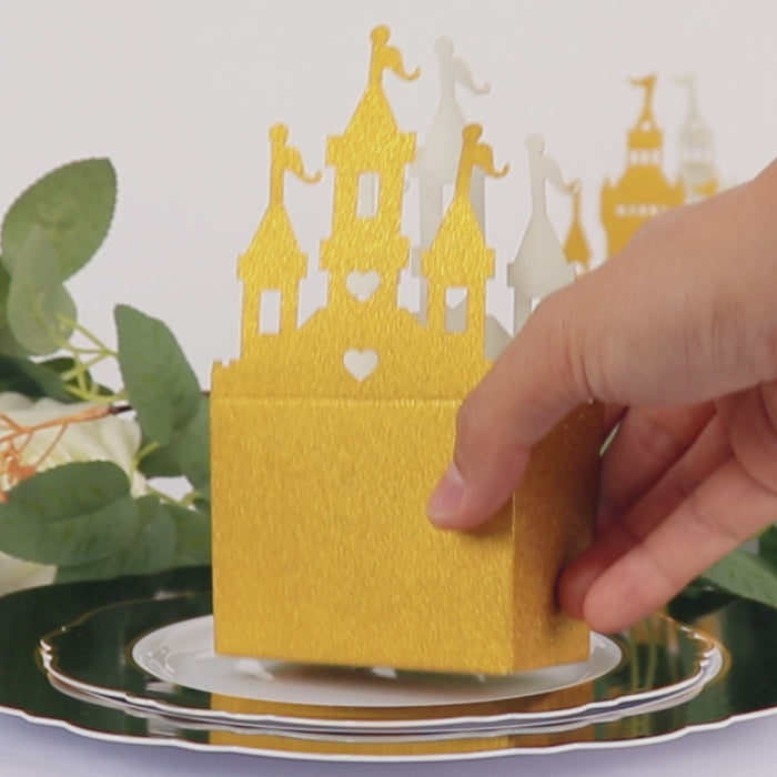 Gold glitter princess castle favor box on a decorative plate.