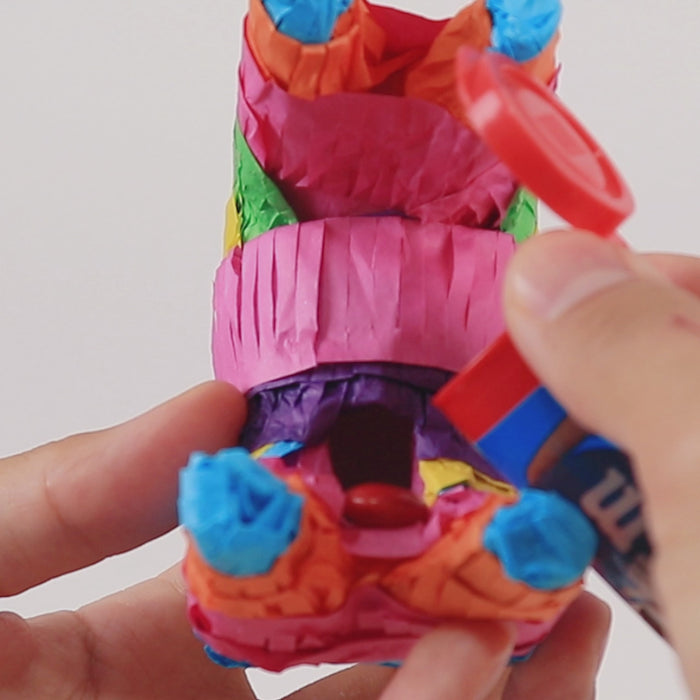 Colorful mini donkey piñata for fiesta party decorations.