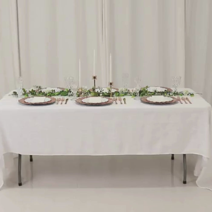 Rose gold charger plates with reef design on a white table setting.