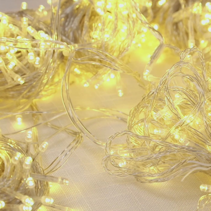 Warm white LED curtain string lights, 10ft x 50ft, perfect for indoor/outdoor use.