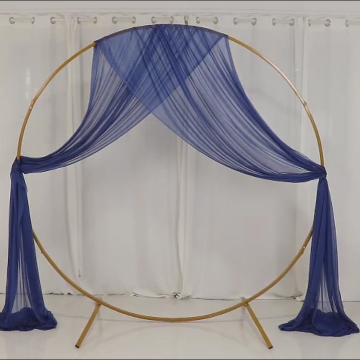 Navy blue sheer wedding arch drape backdrop with gold frame.