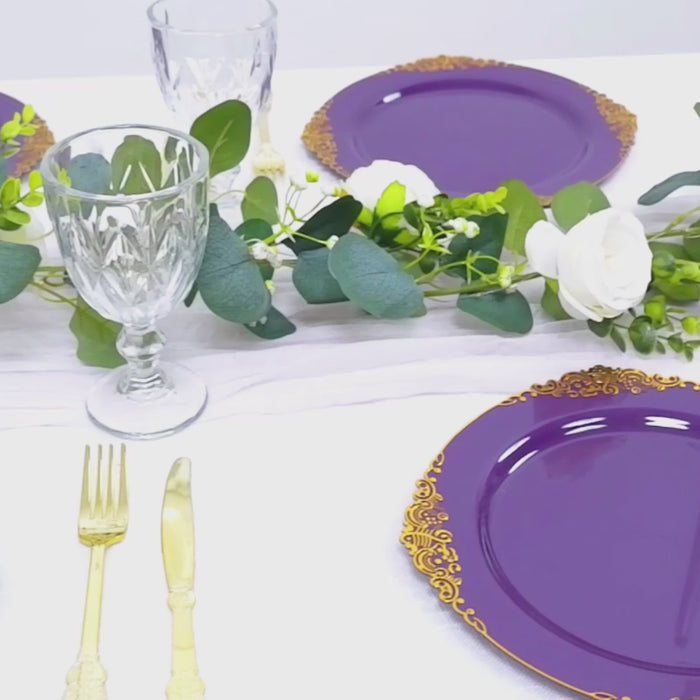 Purple dessert plates with gold leaf rim on a table setting.