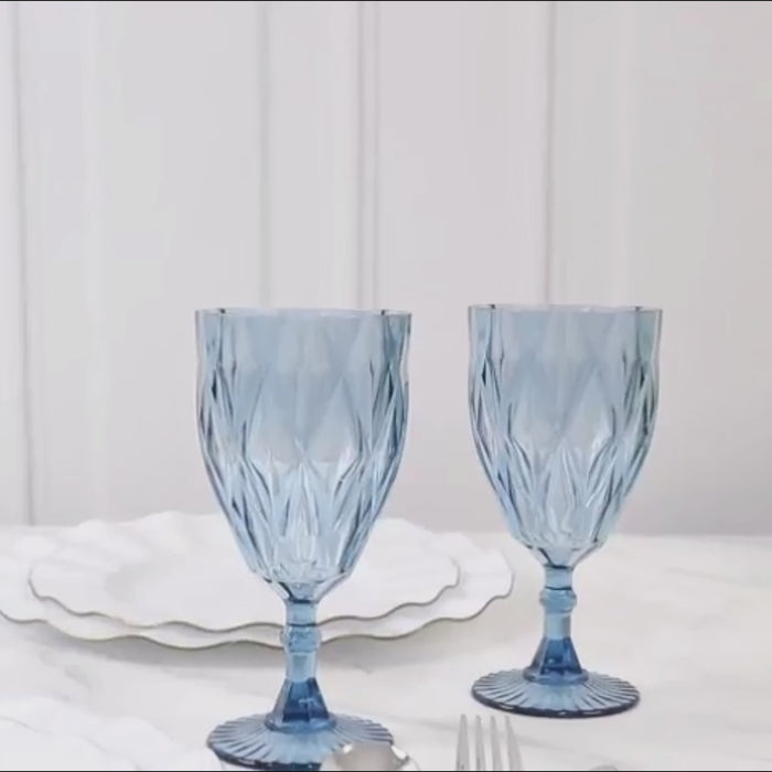Dusty blue vintage plastic wine goblets on a white table setting.