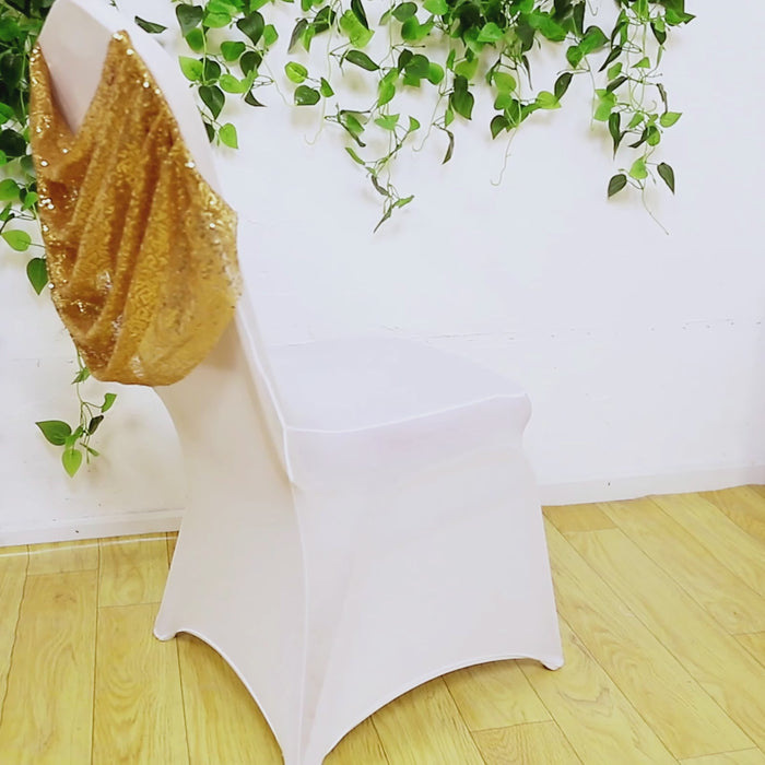 White banquet chair cover with gold sequin swag back and foot pockets.