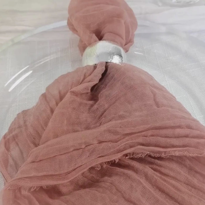 Dusty rose reusable gauze cheesecloth napkins on a table setting.