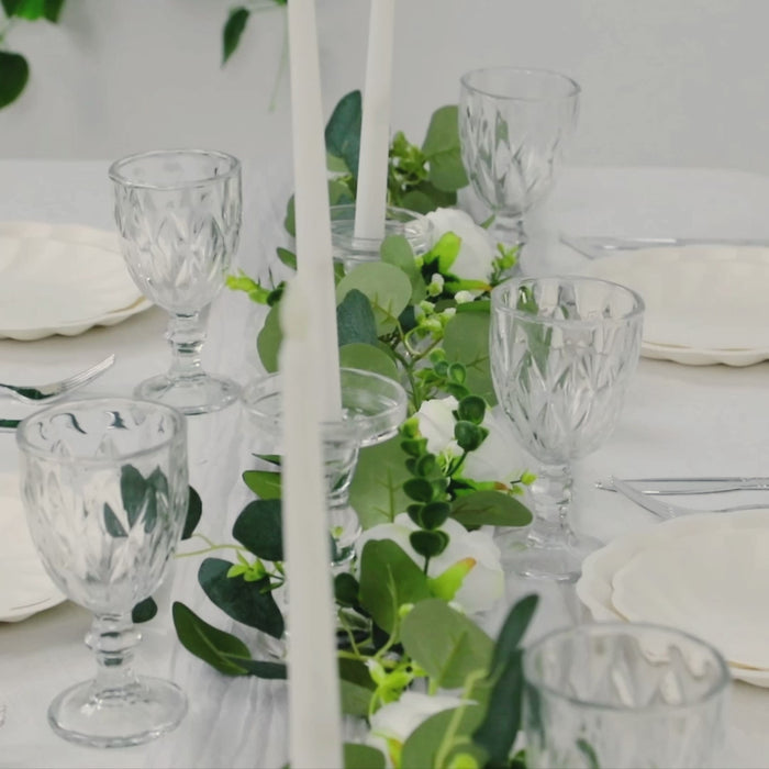 Cream swirl scalloped pastel color dinner plates on a decorated table.