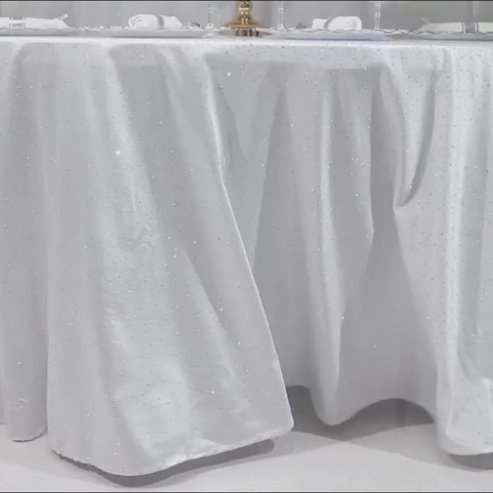 White tablecloth with rhinestone accents for luxury events.