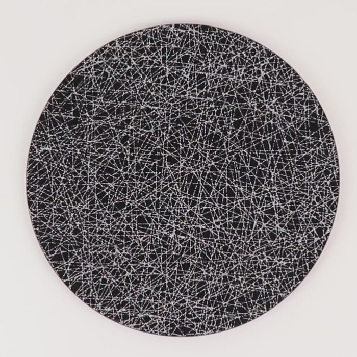 Black acrylic charger plate with glitter silver abstract lines pattern.