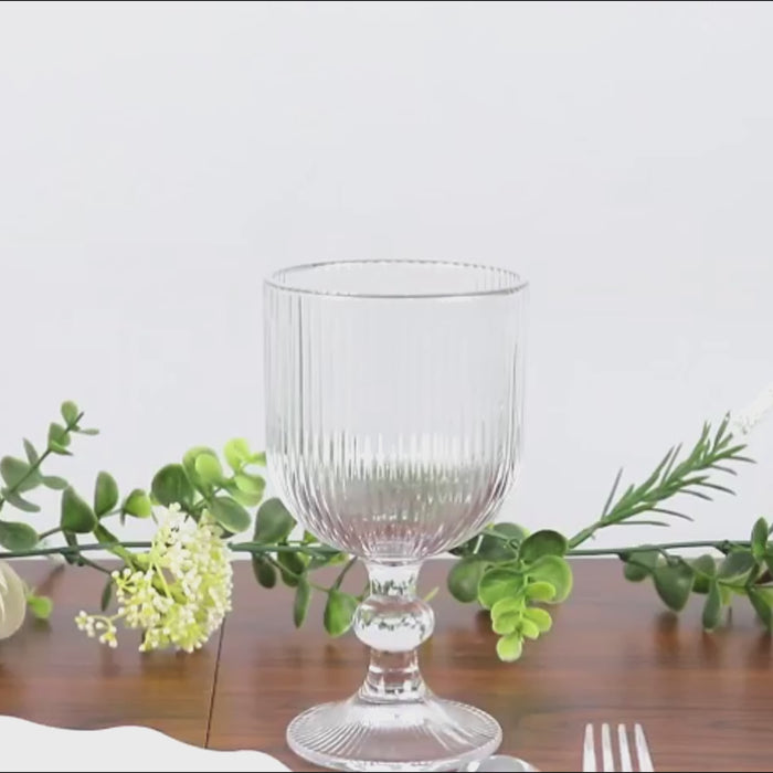 Clear vintage ribbed wine glass with ball stem accent.