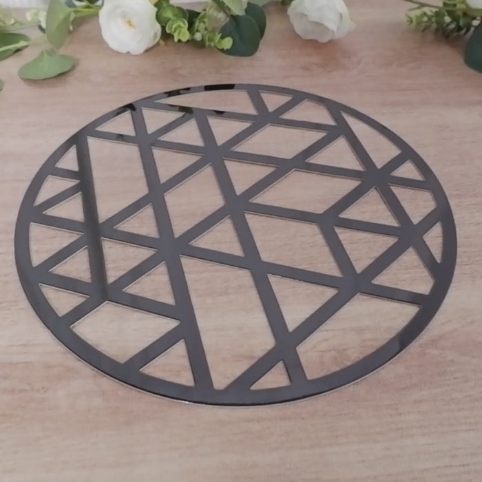 Black geometric triangle design disposable placemat on a wooden surface.